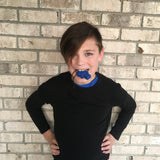 Boy chews on navy blue chew necklace.