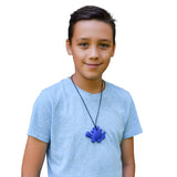 Munchables Navy Stegosaurus Dinosaur Chew Necklace on Black Cord worn by young adult man.