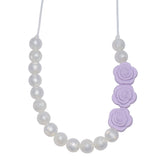 The Munchables Pearl Chew Necklace features pearl beads on only half the necklace and 3 lavender rose beads.