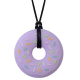 Munchables Purple Donut Chew Necklace with Colourful Sprinkles Strung on a Black Cord.