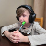 Boy chews on chewable stim pencil topper