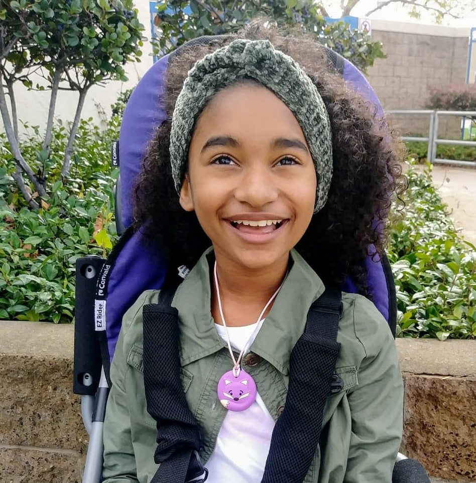 Munchables Round Fox Sensory Chew Necklace in Purple Worn by Smiling Girl.