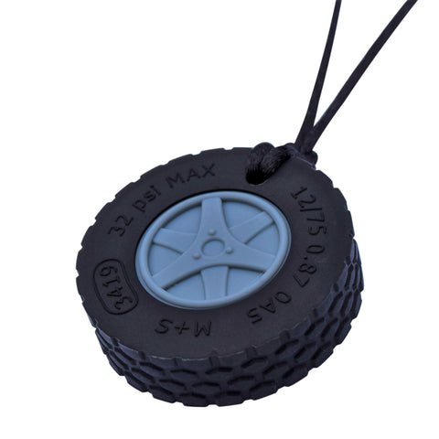 Munchables Tire Chew Necklace features black rubber and a grey hubcap.