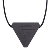 An adult chew necklace in the shape of a triangle with smaller raised geometric triangles on the reverse-side. Shown in a charcoal colour on a black cord.