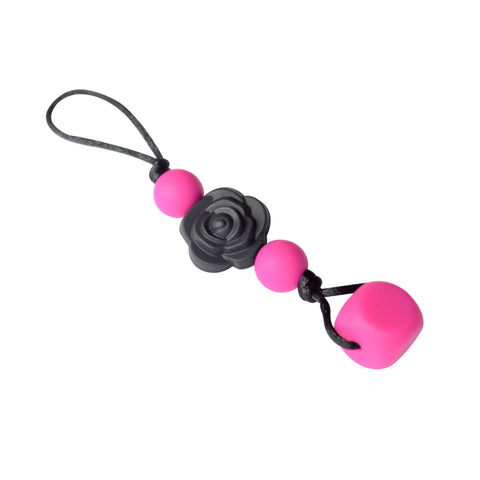 Chewable zipper pull with flower in bright pink and black.