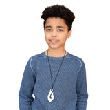A young adult male wears the Munchables Bone Coloured Fish Hook Chew Necklace.