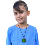 Munchables Green Black Ninja Star Chew Necklace worn by a teen boy.