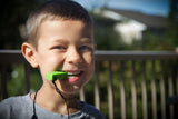 Boy chews green LEGO chew necklace