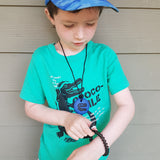 Boy plays with Munchables Stretchy Coil fidget toy bracelets