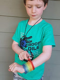 Child wears all 7 rainbow coloured Munchables Stretchy Coil Fidget Bracelets