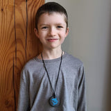 Boy wears blue Munchables Shark Chewelry