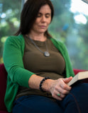Adult woman wearing size large black adjustable sensory bracelet.
