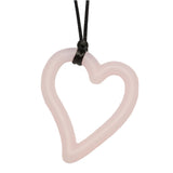 Munchables Heart Chew Necklace in light pink strung on black cord.