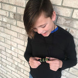 Boys holds green camo LEGO chewable stim