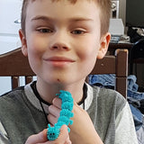 Boy with blue Squishy Caterpillar Stimming Tool