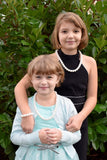 2 Girls wear Munchables pearl chew necklace
