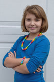 Munchables Rainbow Stimming chew Necklace worn by young girl.