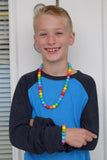 Munchables Rainbow Stim Chew Necklace worn by boy.