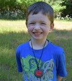 Young Boy wearing Dinosaur Chew Necklace in United States California