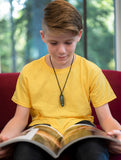 Boy wears Munchables Surfboard Chewelry while reading