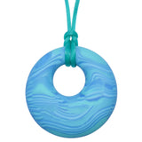 Munchables Aqua Scribbles Chew Necklace features wavy lines of shades of aqua and is strung on an aqua cord.