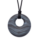 Munchables Gray Scribbles Chew Necklace features wavy lines of grays and blacks and is strung on a black cord.