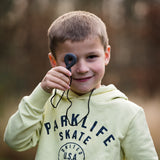 Boy holds up charcoal infinity chewelry