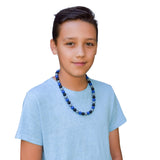 Munchables Midnight Blues Chew Necklace worn by a teenage boy.