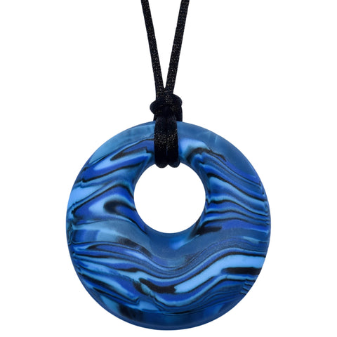 Munchables Navy Blue Scribbles Chew Necklace features wavy lines of blues and blacks and is strung on a black cord.