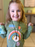 Young girl wearing pink donut anxiety necklace in Fort Worth, Texas.