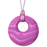 Munchables Pink Scribbles Chew Necklace features wavy lines of purples and pinks and is strung on a light pink cord.