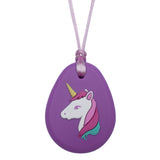 Munchables Purple Unicorn Chew Necklace features a white unicorn with a three coloured mane, a purple eye and a yellow horn strung on a light purple cord.