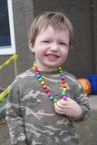 Munchables Rainbow Chewing Anxiety Necklace worn by young boy.