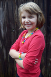 Munchables Rainbow Chew Necklace worn by a girl.