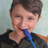 Boy chews on Munchables chewable pencil toppers