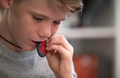 Boy chews on Munchables Red Scorpion Chewelry