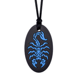 Munchables black oval shaped chew necklace with blue scorpion design.