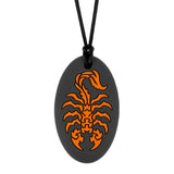 Munchables black oval shaped chew necklace with orange scorpion design.