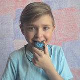 Boy chews on Munchables Shark Chewelry