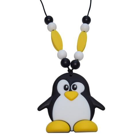 Munchables Mr. Penguin Chew Necklace in yellow, black and white. Features beads on either side of the black cord that it is strung on. 