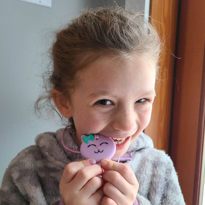 Munchables founder’s daughter chewing the patented purple cat sensory chew necklace for mild to moderate chewers.