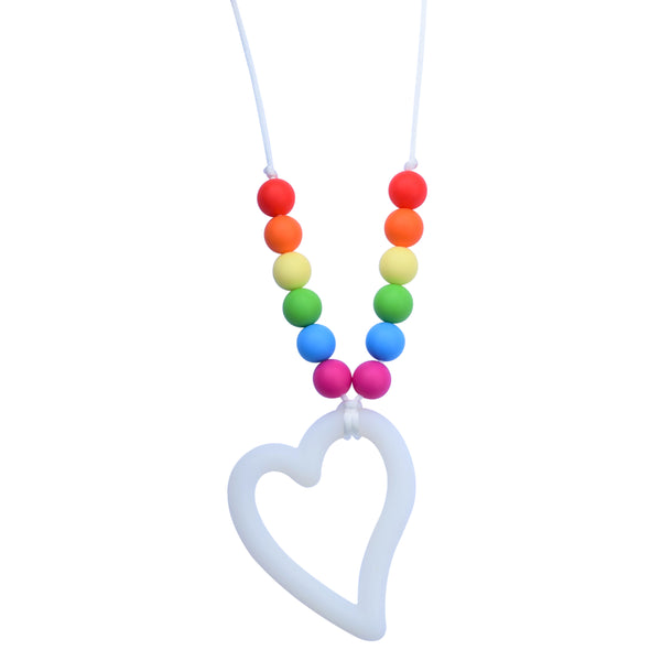 The Munchables Rainbow Heart Chew Necklace features a white heart pendant and 7 colourful round rainbow beads on each arm of the white cord.